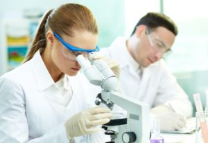15609670 - serious clinician studying chemical element in laboratory